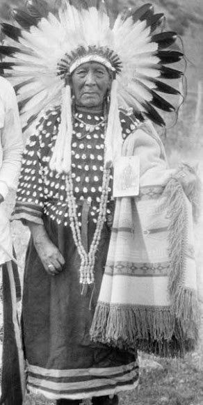 Minnie Hollow Wood wearing the war bonnet she earned for her bravery at the Little Bighorn, photographed around 1925