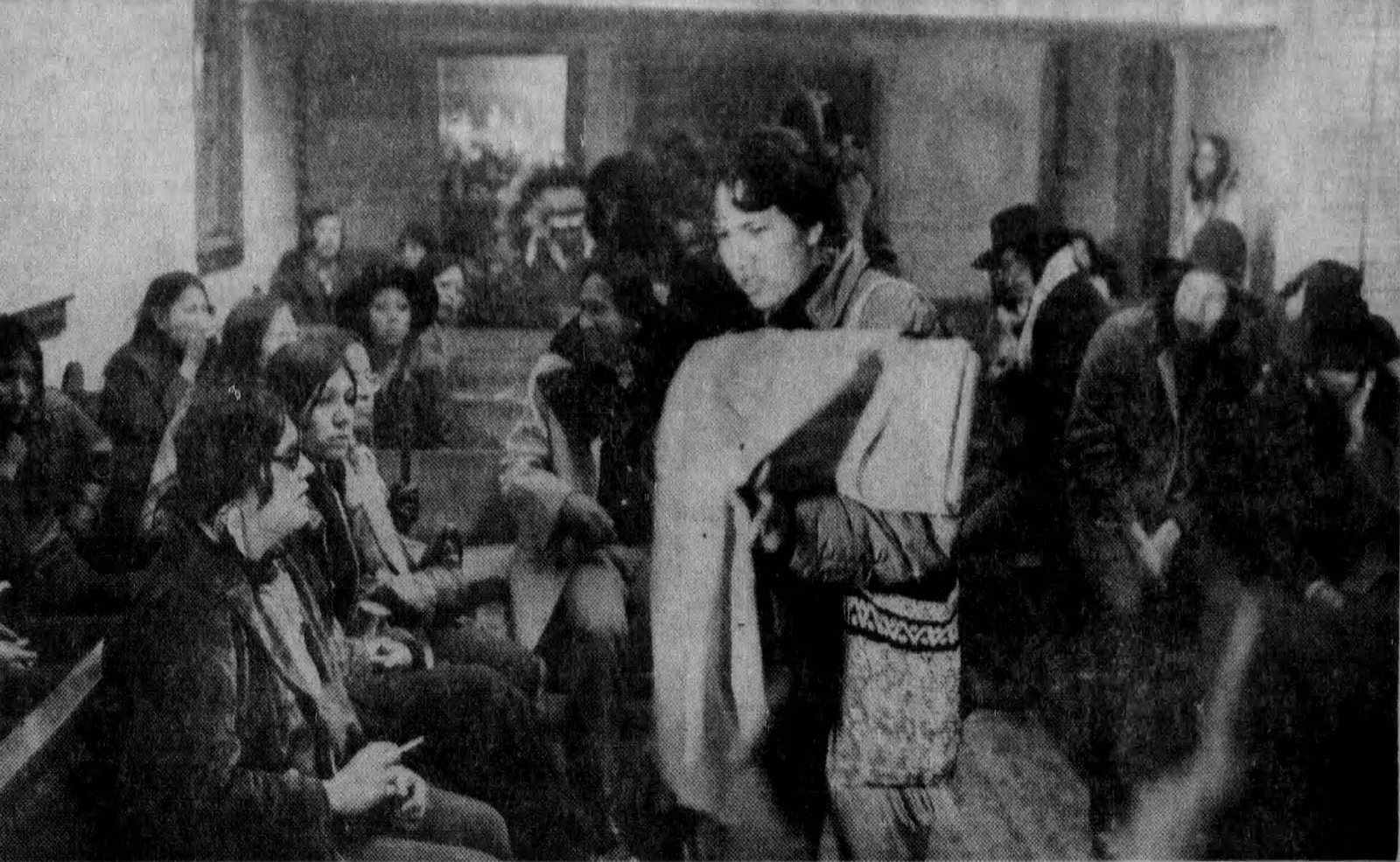 A woman displays a cloth inside the church during the 1973 occupation of Wounded Knee, South Dakota